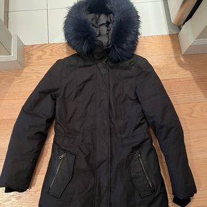 Black Mackage Down Coat with a Navy Blue Fur Hood.